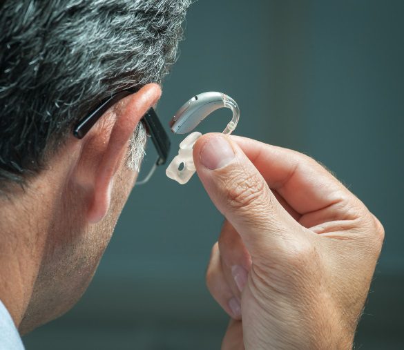 A hearing loss patient being fitted with a hearing aid at Hometown Hearing Centre