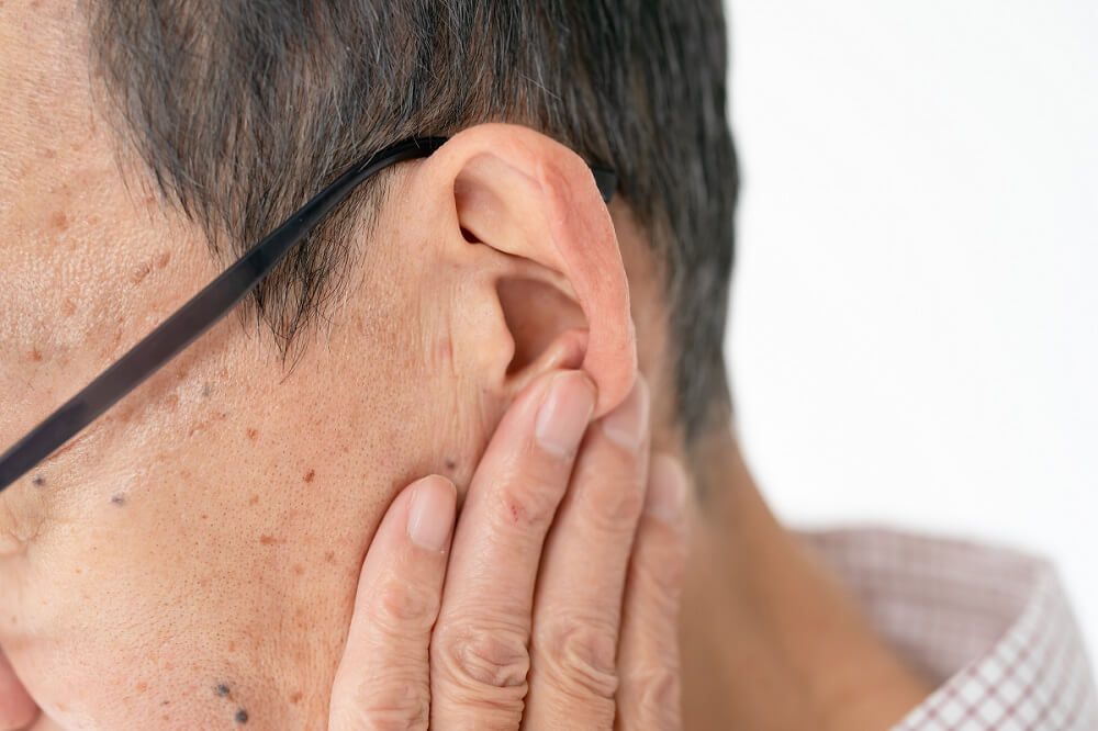 A man with excessive earwax seeking removal at Hometown Hearing Centre